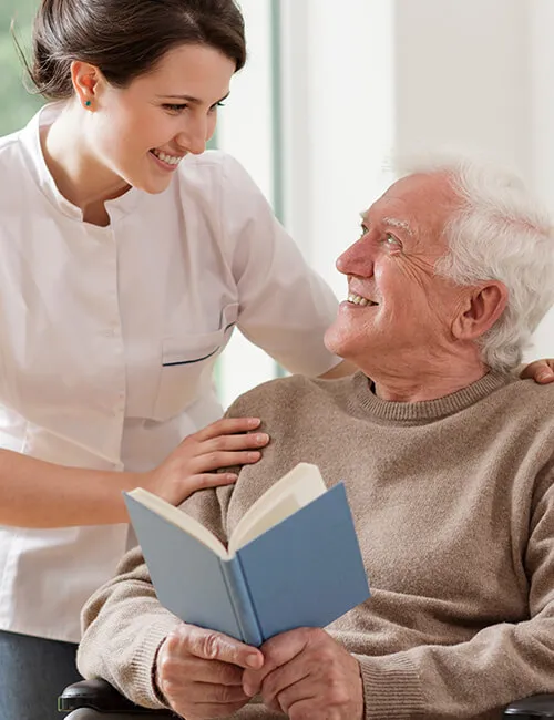 A carer sitting with a client, offering support
